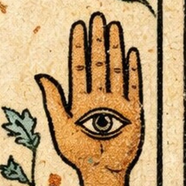 Card detail: the hand of Fatima with an eye in the palm.